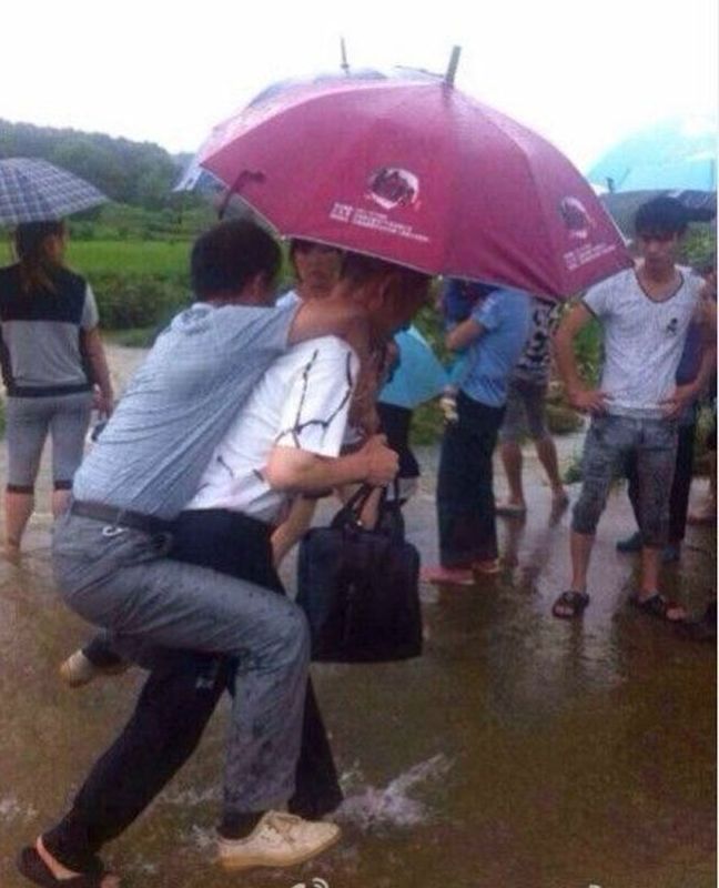 Un oficial chinez demis, după ce a fost cărat în spate, într-o zonă inundată