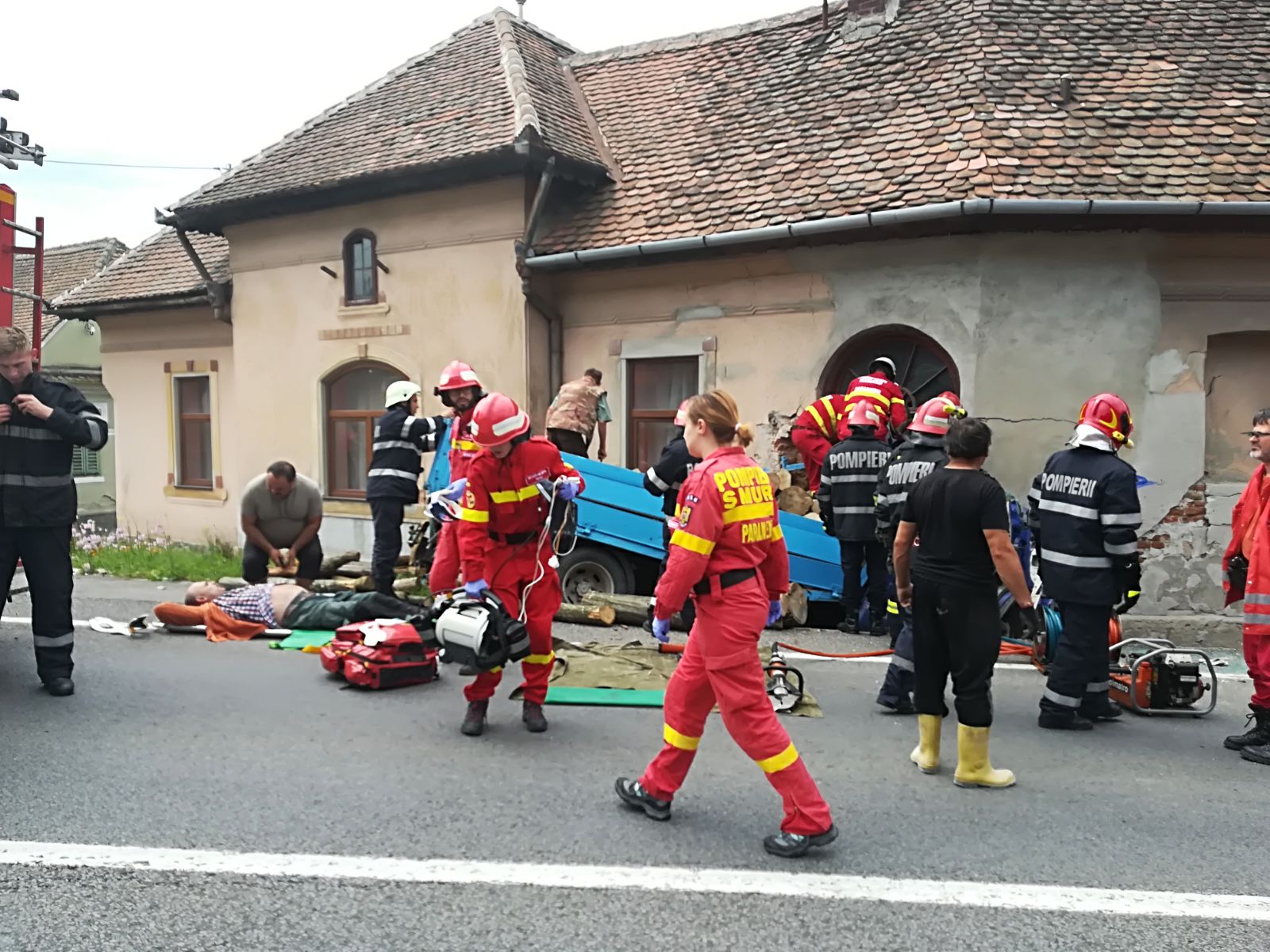 UPDATE FOTO-VIDEO: O mașină încărcată cu lemne s-a izbit într-o casă la Apoldu de Sus. Două persoane sunt încarcerate